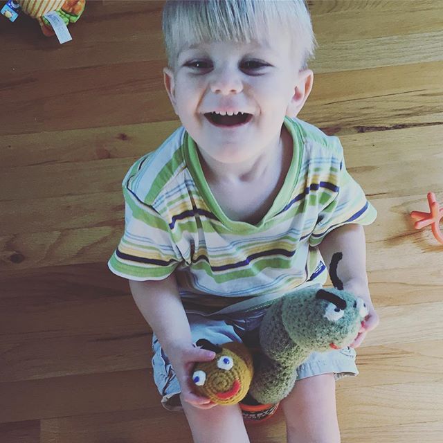 Instagram: Two crocheted worms. The gold one was made by my mom for me when I was little. The green one was made my my mom for E last year. I love that he's playing with my toys!